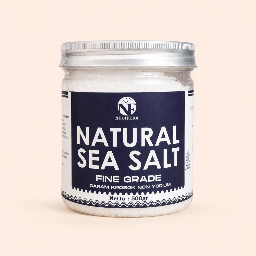 Cover produk Nucifera Natural Sea Salt Fine Grade 500gr dengan latar krem