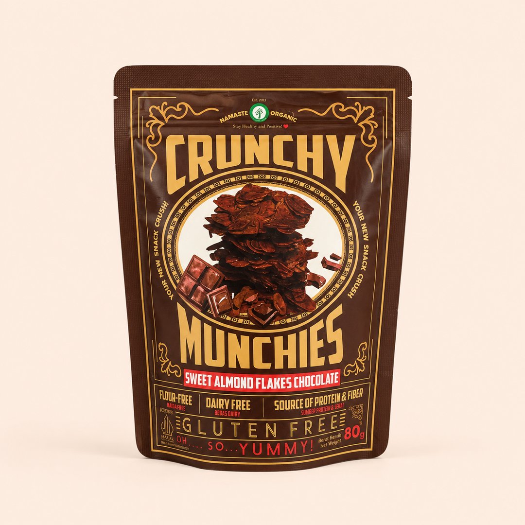 Cover produk Namaste Organic Crunchy Munchies Sweet Almond Flakes Chocolate 80g dengan latar krem